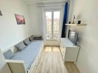 a small room with a bed and a window at Studio au coeur de Nice in Nice