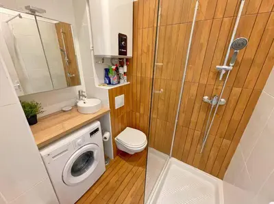 a bathroom with a shower and a washing machine at Studio au coeur de Nice in Nice