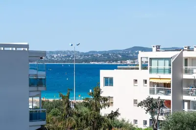 a view of the ocean from a building at Résidence méditerranée - Beachfront - Sun and Seaview - Pool - Private Parking in Cagnes-sur-Mer
