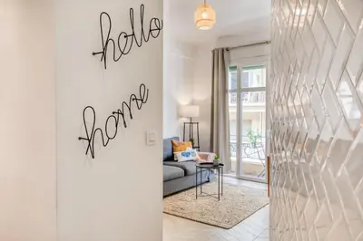 a living room with a couch and a table at #10 2Pièces Fricéro 3min to the beach/Balcon & AC in Nice