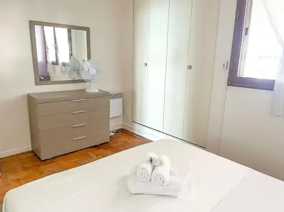a bedroom with white towels on a bed with a mirror at Horizon in Saint-Laurent-du-Var