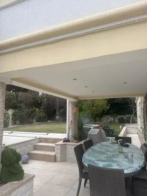 a patio with a table and chairs on a patio at Studio proche mer avec piscine Cros de cagnes in Cagnes-sur-Mer
