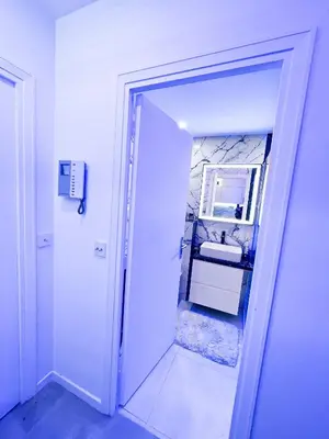 a white bathroom with a sink and a mirror at Promenade-des-anglais-front-sea in Nice