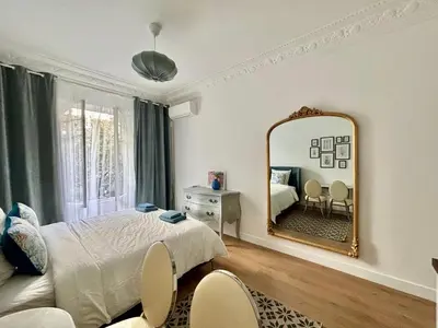 a bedroom with a bed and a mirror at Studio 2 steps from the sea near the Negresco hotel in Nice