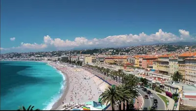 a view of a beach with people and the ocean at Studio 2 steps from the sea near the Negresco hotel in Nice