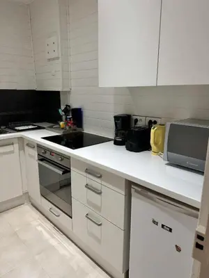 a white kitchen with a stove and a microwave at MY CASA - BOSIO RAOUL - Central few steps to the sea in Nice