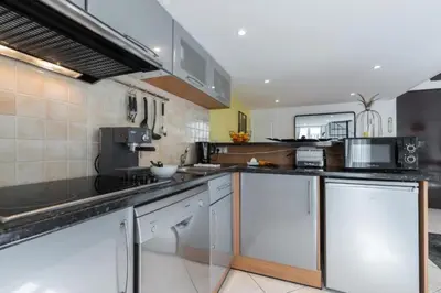 a large kitchen with stainless steel counters and appliances at MY CASA - MASSENA 2 - Great location Massena Square with AC in Nice