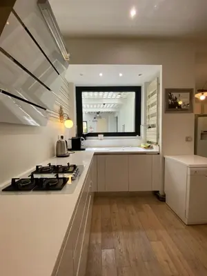a kitchen with a stove and a sink and a window at Villa avec piscine, Nice Centre in Nice
