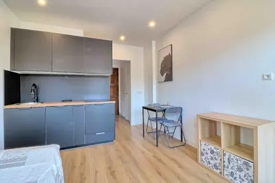 a kitchen with a sink and a table in a room at Accès direct Promenade Des Anglais - Negresco in Nice