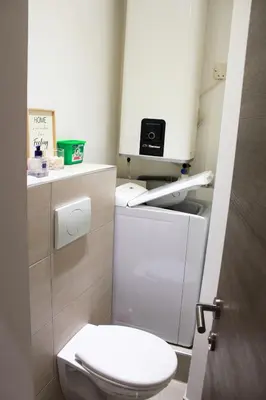 a bathroom with a white toilet in a room at Lofty - Massena sq - 5 min walk Beach in Nice