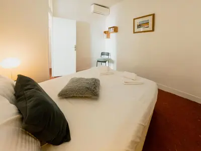 a white bed with two pillows on top of it at Old Town- 4 Pers, Vieux Nice, AC, wifi in Nice
