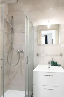 a bathroom with a shower and a sink and a glass shower stall at #44 1 BDR Flat Cap AC balcony 5mins walk to beach in Nice