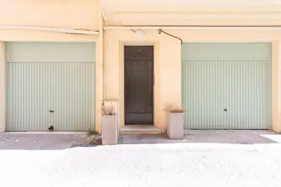 two garages with a door in a building at #44 1 BDR Flat Cap AC balcony 5mins walk to beach in Nice