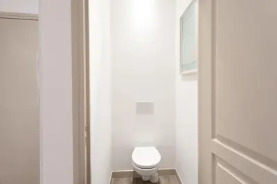 a bathroom with a white toilet and a door at #44 1 BDR Flat Cap AC balcony 5mins walk to beach in Nice