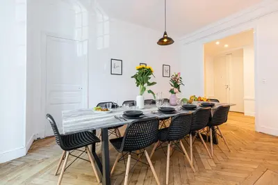 a dining room with a table and chairs at FEEL HOME - FOCH 28 in Nice