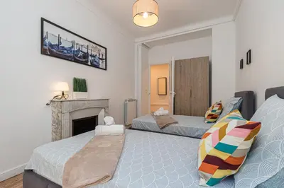 a bedroom with two beds and a fireplace at FEEL HOME - FOCH 28 in Nice