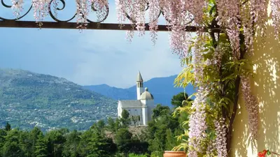 a view of a church from a window with flowers at Villa Kilauea B&B in Nice