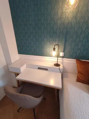 a bedroom with a desk and a bed with a lamp at Boutique Studio 1 in Nice