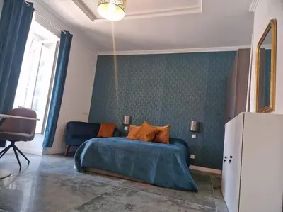 a bedroom with a blue bed in a room at Boutique Studio 2 in Nice