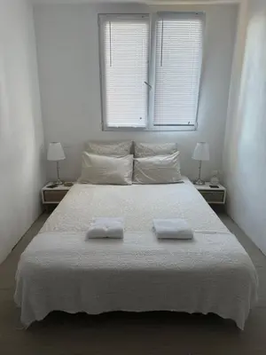 a bedroom with a large bed with two towels on it at Location dans résidence privée,sécurisée ,parking gratuit , 1 minute du tramway, à 9 minute du centre ville, accessible à plusieurs transports in Nice