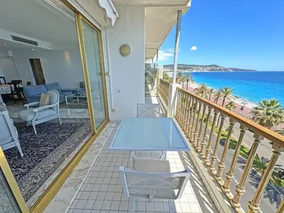 a balcony with a table and a view of the ocean at Panoramic Sea View Promenade in Nice