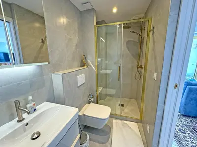 a bathroom with a shower and a toilet and a sink at Panoramic Sea View Promenade in Nice