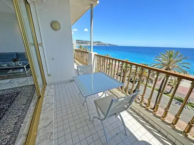 a table and chairs on a balcony with the ocean at Panoramic Sea View Promenade in Nice