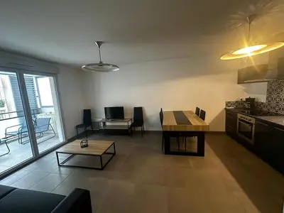 a kitchen and a living room with a table and a tableablish at Superbe Appartement terrasse 2P à 5 min à pied du vieux Nice, du port et du Tram in Nice