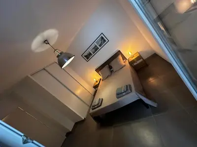 an overhead view of a room with a bed and a lamp at Superbe Appartement terrasse 2P à 5 min à pied du vieux Nice, du port et du Tram in Nice