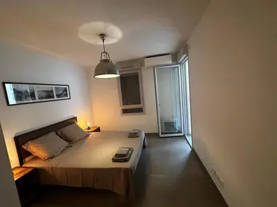 a bedroom with a bed in a room with a window at Superbe Appartement terrasse 2P à 5 min à pied du vieux Nice, du port et du Tram in Nice