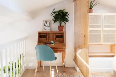 a desk in a room with a blue chair at #48 Suite Jean top floor terrace 5min walk sea AC in Nice