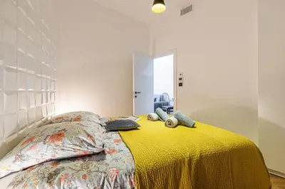 a bedroom with a bed with a yellow bedspread at MY CASA - FOCH - Superb Suite w AC Downtown in Nice