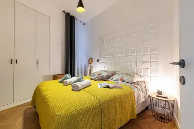 a bedroom with a yellow bed with towels on it at MY CASA - FOCH - Superb Suite w AC Downtown in Nice