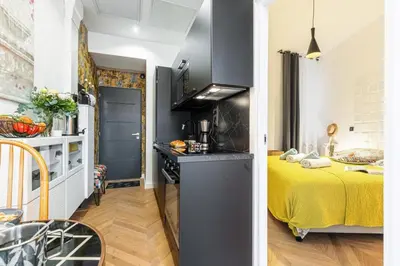 a small room with a yellow bed and a kitchen at MY CASA - FOCH - Superb Suite w AC Downtown in Nice