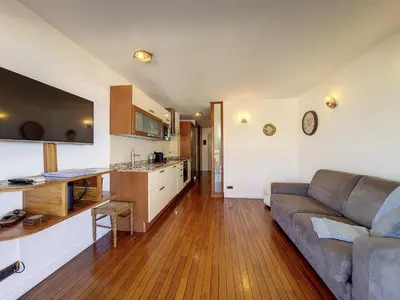 a living room with a couch and a kitchen at Nestor&Jeeves - HUBLOT TERRASSE - Sea view - swimming pool in Nice