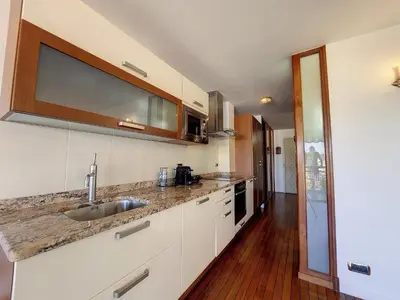 a kitchen with a sink and a counter top at Nestor&Jeeves - HUBLOT TERRASSE - Sea view - swimming pool in Nice