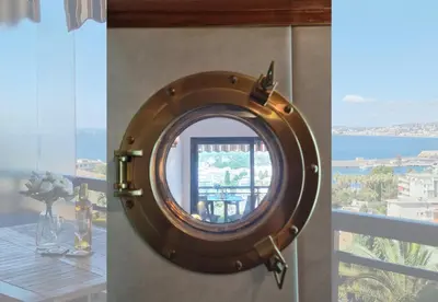 a round mirror on a wall in a room with a window at Nestor&Jeeves - HUBLOT TERRASSE - Sea view - swimming pool in Nice