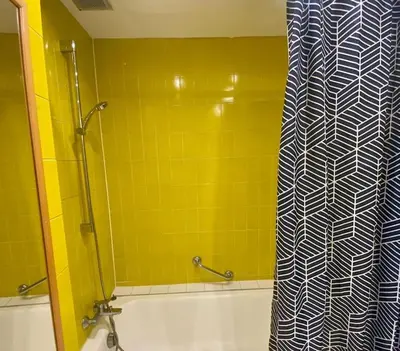 a bathroom with a shower curtain and a tub at Coeur de Nice emplacement idéal in Nice