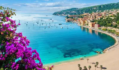 a view of a beach with people in the water at Signature Penthouse at Villefranche, Steps to Beach, Limited-Time Offer in Villefranche-sur-Mer