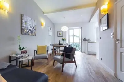 a living room with a couch and a table at Signature Penthouse at Villefranche, Steps to Beach, Limited-Time Offer in Villefranche-sur-Mer