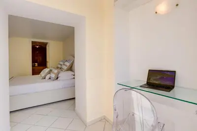 a bedroom with a bed and a laptop on a desk at Mont Boron Exclusive Apartment in Villa Belle Époque in Nice