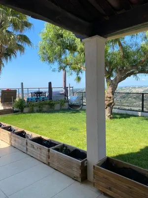 a porch with a view of the beach and a tree at Logement privé Nice - Crémat in Nice
