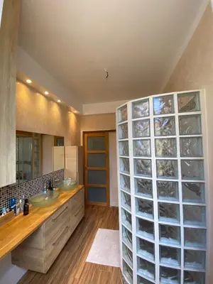 a bathroom with two sinks and a large glass wall at 3 P 75 M2 Centre de nice in Nice