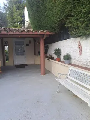 a white bench sitting in front of a house at Maison du bonheur calme et verdure in Nice