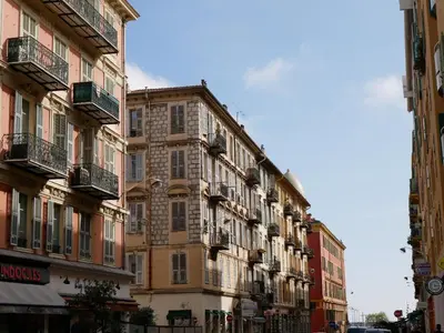 a large building with balconies on a city street at LOVELY STUDIO - Port de Nice in Nice