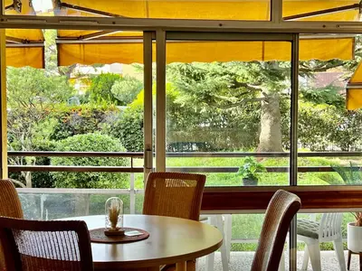 a table and chairs in front of a window at Appartement Nice aéroport seafront with pool in Cros-de-Cagnes