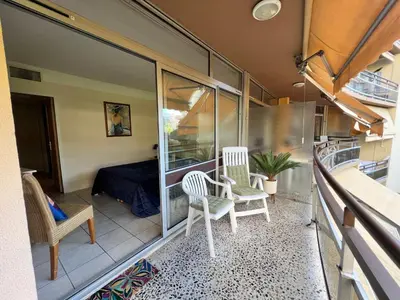 a balcony of a house with two chairs and a bed at Appartement Nice aéroport seafront with pool in Cros-de-Cagnes