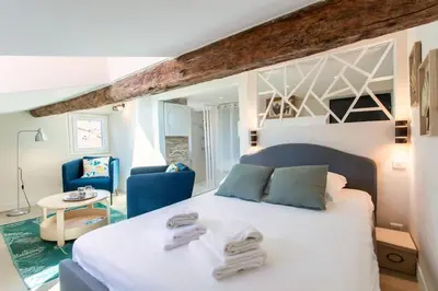 a bedroom with a white bed with towels on it at #49 Perfect location Saleya old town 2mins to Sea AC in Nice