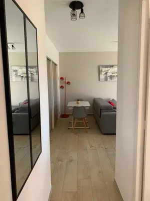 a living room with a couch and a table at Agréable 2 pièces à 150 m de la mer in Cagnes-sur-Mer