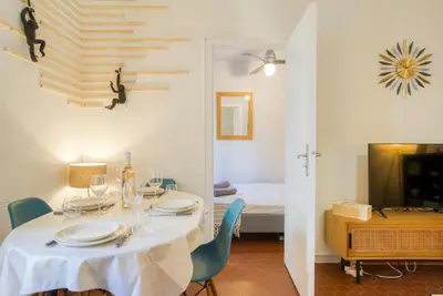 a hallway with a mirror and a basket on a chair at Cosy, modern, fully equipped, air conditioning, Nice historical, old town, 1minute walk from beach - 